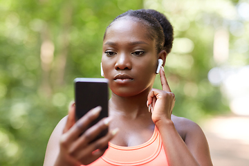 Image showing african american woman with earphones and phone