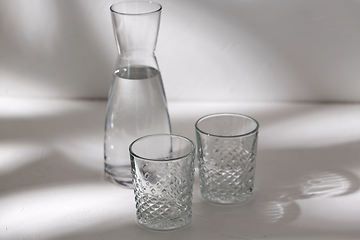 Image showing two glasses and jug with water on white background