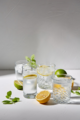 Image showing glasses with lemon water and peppermint on table