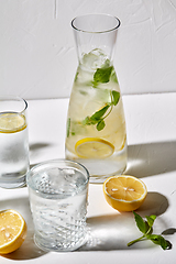 Image showing glasses with lemon water and peppermint on table