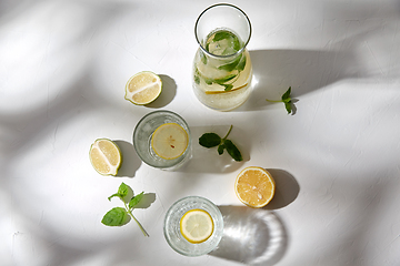 Image showing glasses with lemon water and peppermint on table