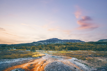 Image showing Steamy river with a geyser basin