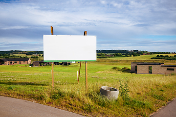 Image showing Large billboard sign on a green field