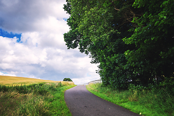 Image showing Curvy countryside road surrounded by fields