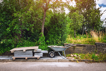 Image showing Wheelbarrow with tiles on a street