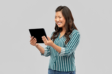 Image showing happy asian woman using tablet computer