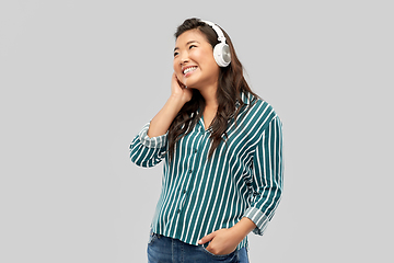 Image showing asian woman in headphones listening to music