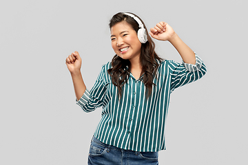 Image showing asian woman in headphones listening to music