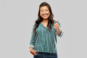 Image showing happy asian woman in glasses showing thumbs up