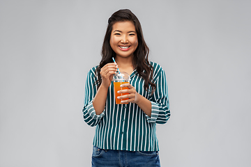 Image showing asian woman with juice in plastic cup with straw