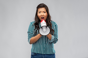 Image showing angry young asian woman speaking to megaphone