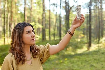 Image showing woman or witch performing magic ritual in forest