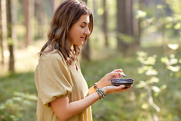 Image showing woman or witch performing magic ritual in forest