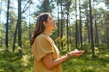 Image showing young woman or witch holding pyramid in forest