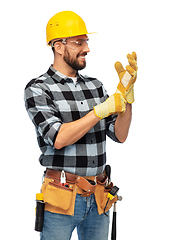 Image showing happy male worker or builder in helmet and gloves