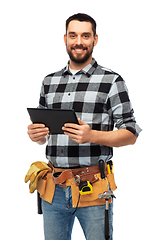 Image showing happy builder with tablet computer and tools