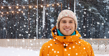 Image showing happy young man at ice skating rink in winter