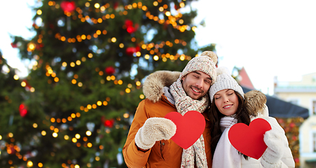 Image showing happy couple with red hearts at christmas market