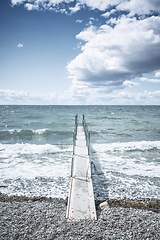 Image showing Small pier at a cold sea with waves coming in