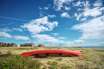 Image showing Red kayak on the shore in the summer