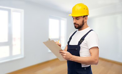 Image showing male worker or builder in helmet with clipboard