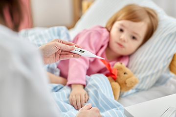 Image showing doctor measuring sick girl's temperature