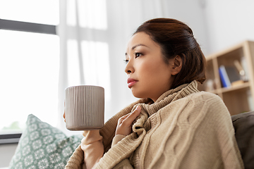 Image showing sick asian woman drinking hot tea at home