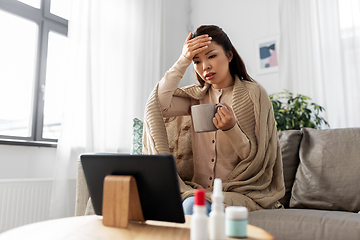 Image showing sick woman having video call on tablet pc at home