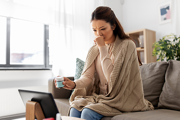 Image showing sick woman with medicine has video consultation