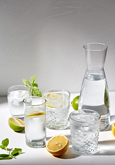 Image showing glasses with lemon water and peppermint on table