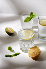 Image showing glasses with lemon water and peppermint on table