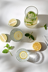 Image showing glasses with lemon water and peppermint on table