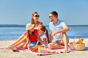 Image showing happy family having picnic on summer beach