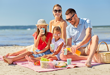 Image showing happy family having picnic on summer beach