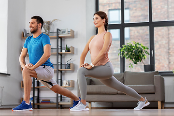 Image showing couple exercising and doing lunge at home