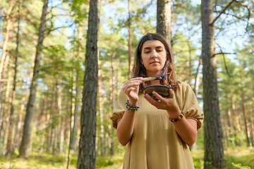 Image showing woman or witch performing magic ritual in forest