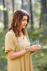 Image showing woman or witch performing magic ritual in forest