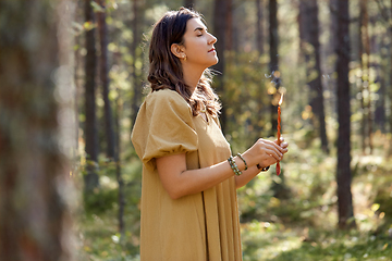 Image showing woman or witch performing magic ritual in forest