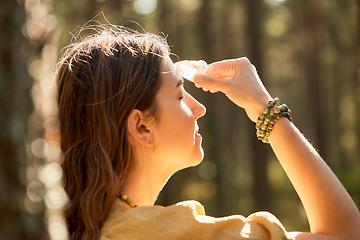 Image showing woman or witch performing magic ritual in forest