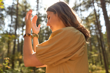 Image showing woman or witch performing magic ritual in forest