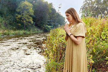 Image showing woman or witch performing magic ritual on river