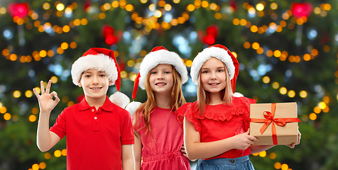 Image showing happy smiling children with christmas gift