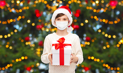 Image showing boy in protective mask with christmas gift