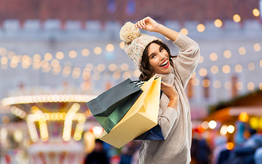 Image showing young woman in winter hat with shopping bags