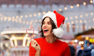 Image showing happy young woman in santa hat on christmas