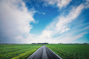 Image showing Asphalt road going through a rural landscape