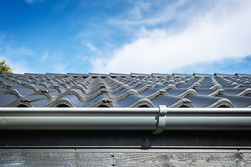 Image showing Roof on a house with tiles and a gutter