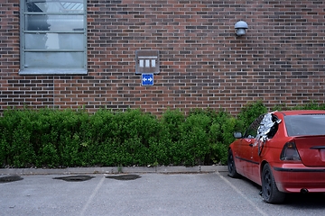 Image showing wrecked red car in the parking lot