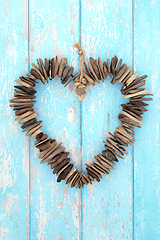 Image showing Driftwood Heart Shaped Wreath Sculpture on Rustic Blue Wood 