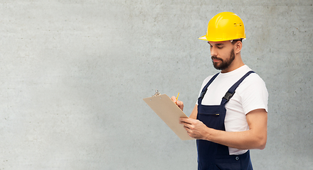 Image showing male worker or builder in helmet with clipboard